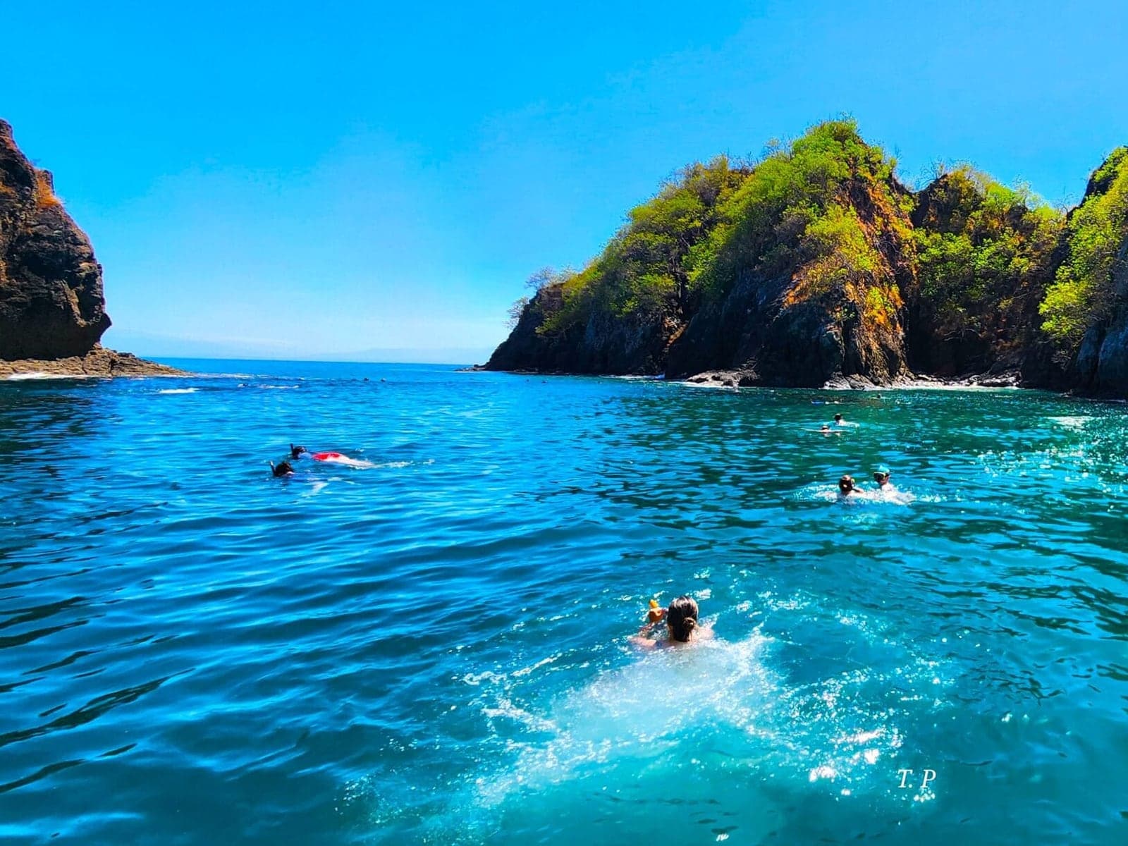 Snorkelers in turquoise water off Tortuga Island, Costa Rica