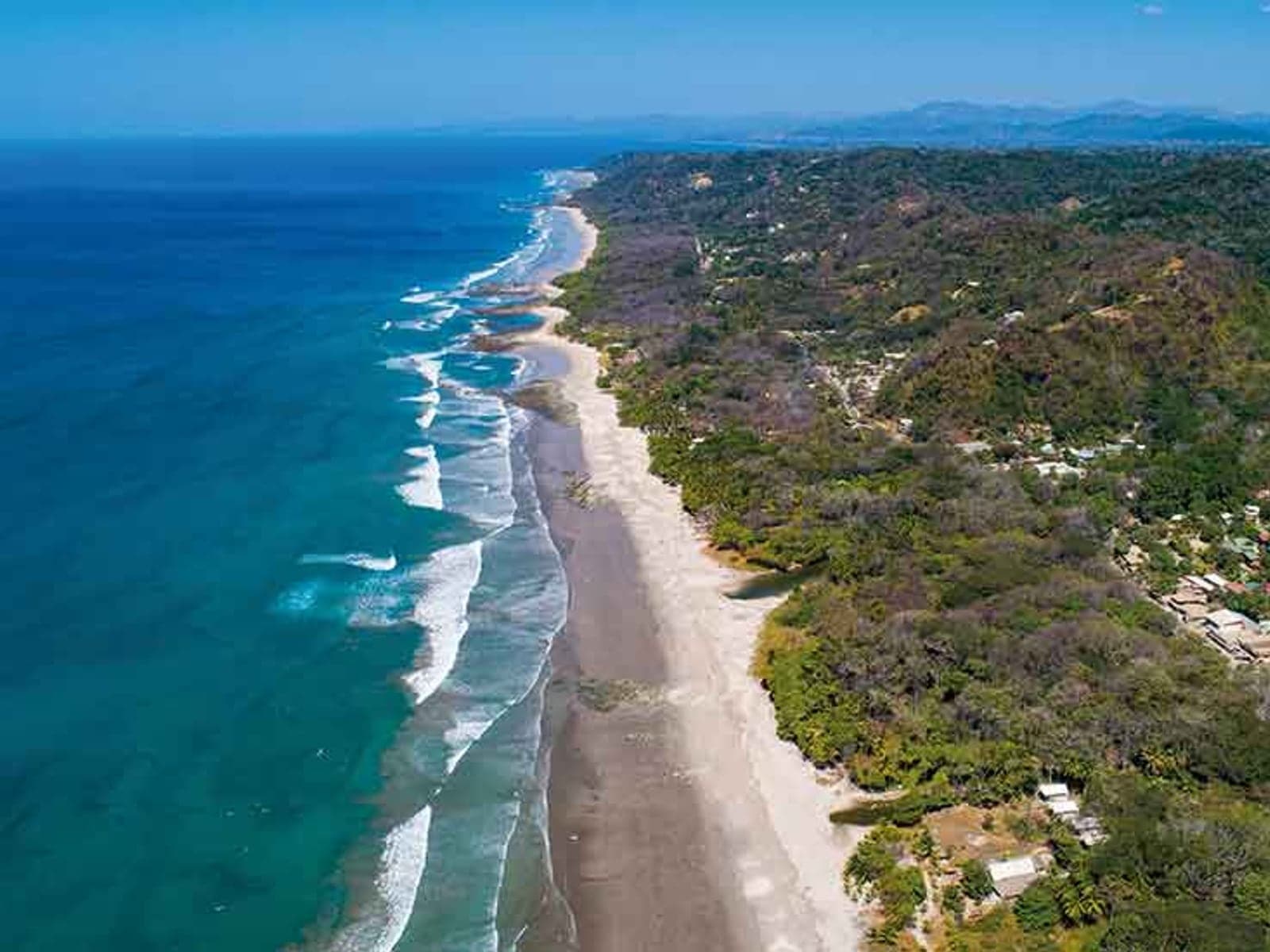 Aerial view of Santa Teresa coastline in dry-season sun
