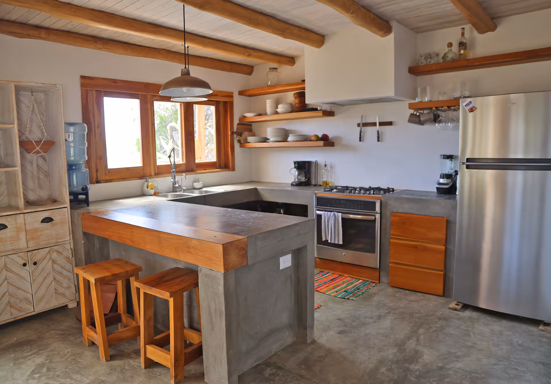 Kitchen island with wooden bar stools and natural light